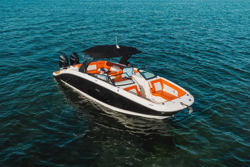 Slide: The Image of 2019 Sea Ray SDX 290 Outboard boat on open water, featuring orange seating and black canopy. - 18