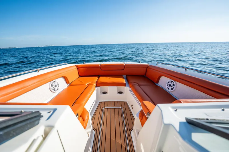 Slide: The Image of 2019 Sea Ray SDX 290 Outboard boat with orange seating, cruising on open water. - 20