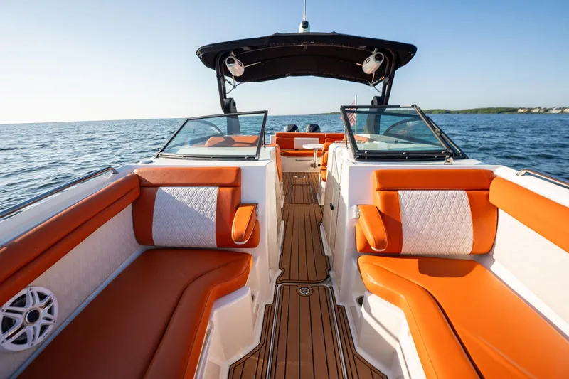 Slide: The Image of 2019 Sea Ray SDX 290 Outboard boat with orange seating on open water. - 24