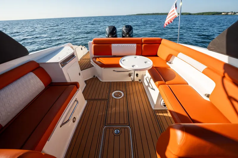 Slide: The Image of 2019 Sea Ray SDX 290 Outboard boat with orange seating and wooden deck. - 26