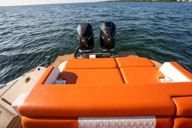 Slide: The Image of 2019 Sea Ray SDX 290 Outboard with orange seating, dual engines on open water. - 27