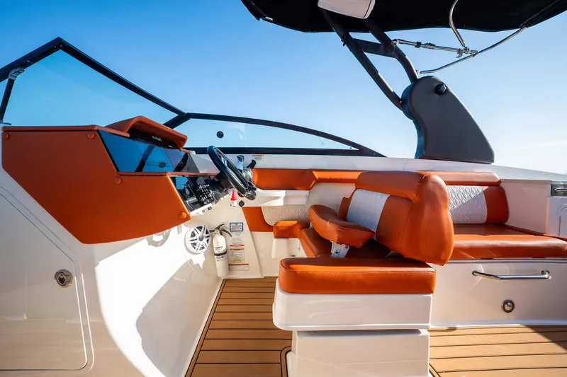 Slide: The Image of 2019 Sea Ray SDX 290 Outboard boat interior with orange seating and modern dashboard. - 38