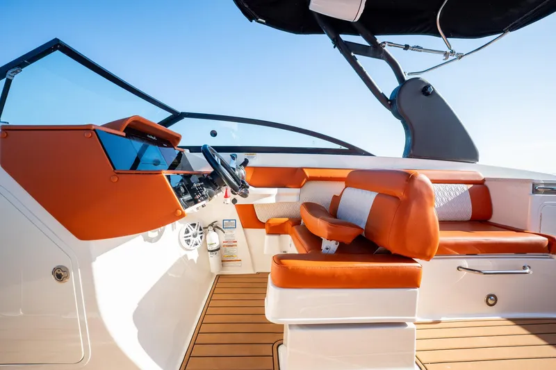 Slide: The Image of 2019 Sea Ray SDX 290 Outboard boat interior with orange and white seating. - 39