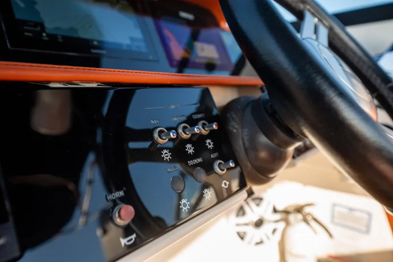 Slide: The Image of 2019 Sea Ray SDX 290 Outboard dashboard with steering wheel and control panel. - 42
