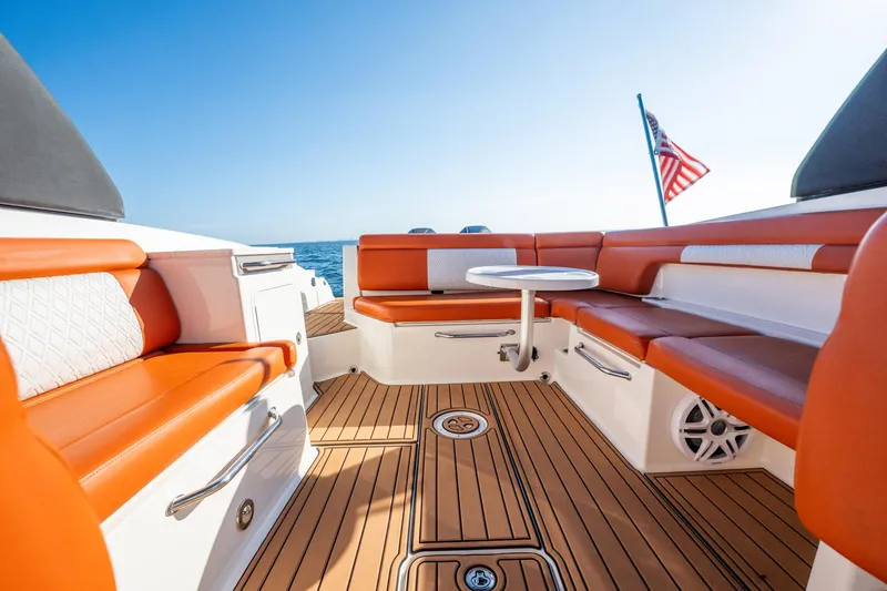 Slide: The Image of 2019 Sea Ray SDX 290 Outboard boat interior with orange seating and American flag. - 44