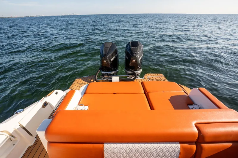 Slide: The Image of 2019 Sea Ray SDX 290 Outboard with orange seating, dual engines on open water. - 45
