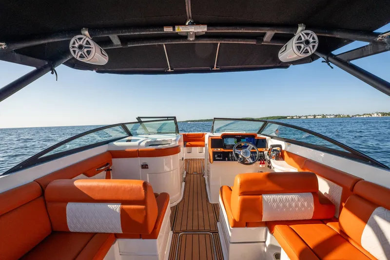 Slide: The Image of 2019 Sea Ray SDX 290 Outboard boat interior with orange seating, on open water. - 46