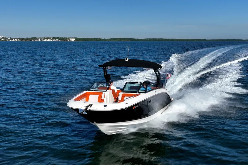 Slide: The Image of 2019 Sea Ray SDX 290 Outboard cruising on open water under clear blue skies. - 51