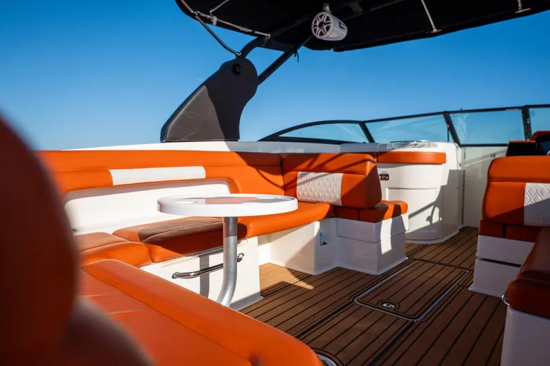 Slide: The Image of 2019 Sea Ray SDX 290 Outboard boat interior with orange seating and wooden flooring. - 55