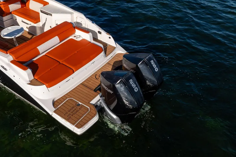 Slide: The Image of 2019 Sea Ray SDX 290 Outboard with twin Mercury engines and orange seating on water. - 6