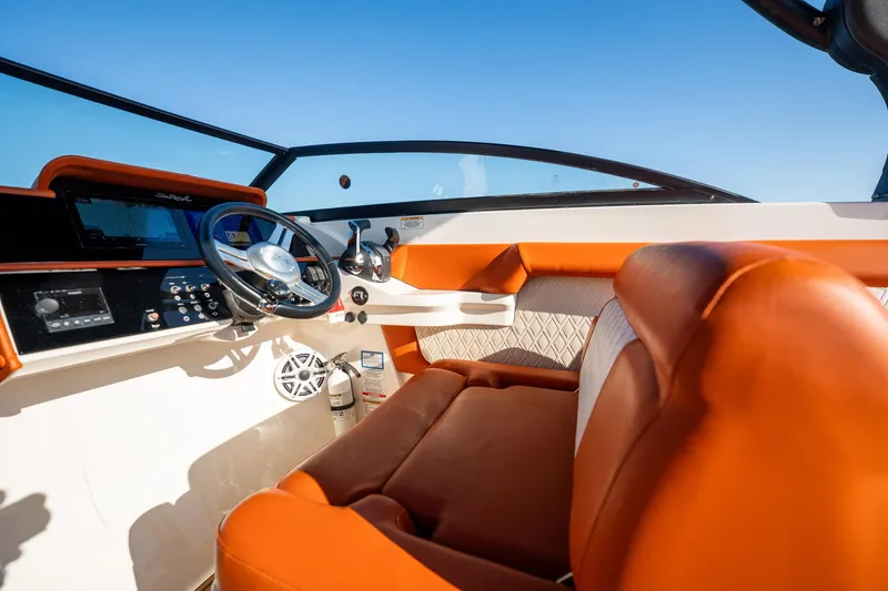 Slide: The Image of 2019 Sea Ray SDX 290 Outboard boat interior with orange seating and modern dashboard. - 60