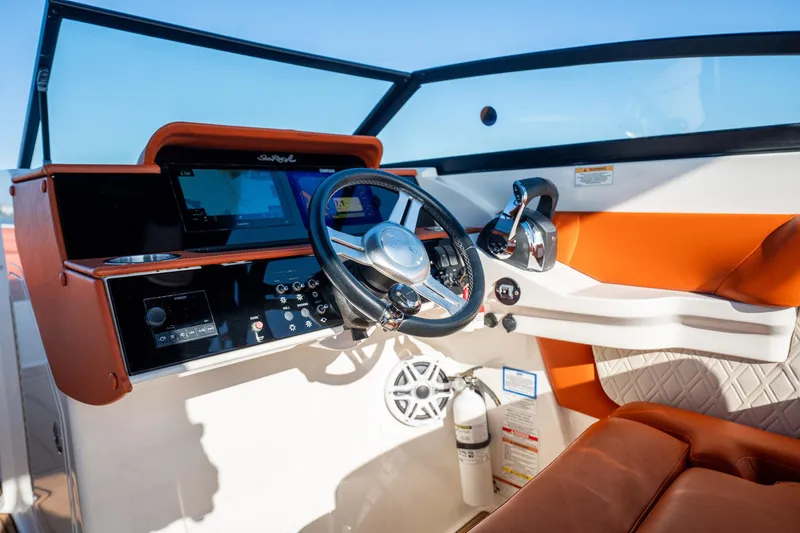 Slide: The Image of 2019 Sea Ray SDX 290 Outboard helm with modern controls and orange seating. - 61