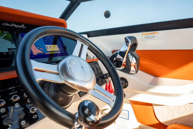 Slide: The Image of 2019 Sea Ray SDX 290 Outboard helm with steering wheel and control panel. - 62