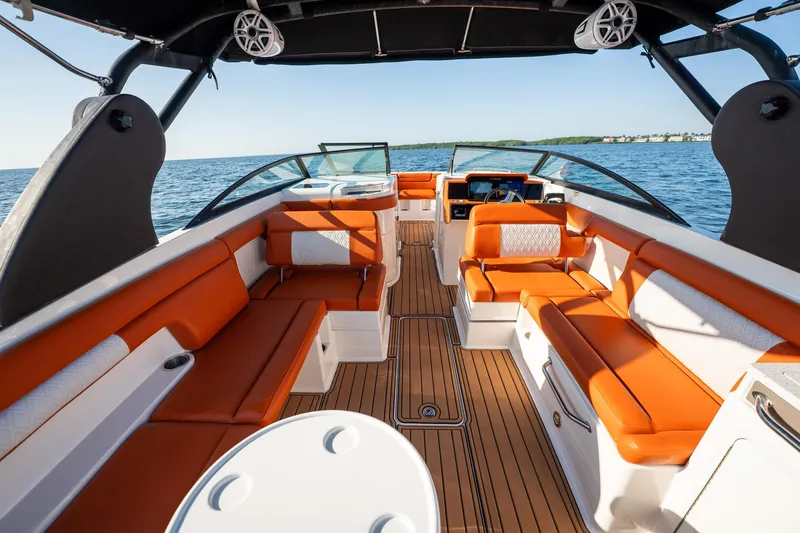 Slide: The Image of 2019 Sea Ray SDX 290 Outboard boat interior with orange seating and wood flooring. - 69