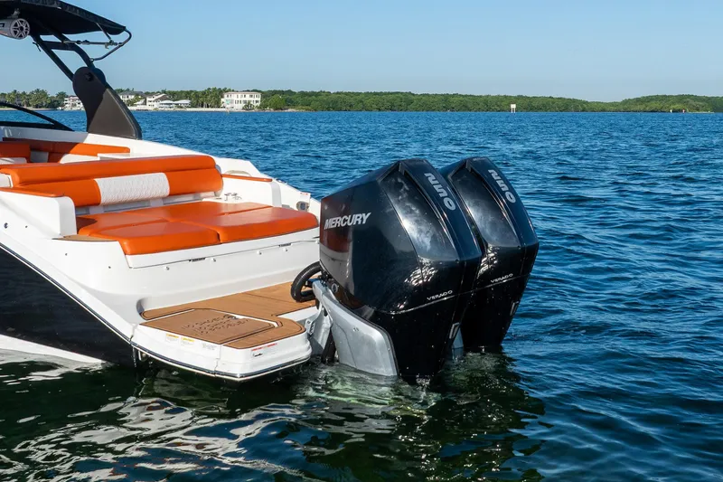 Slide: The Image of 2019 Sea Ray SDX 290 Outboard with dual Mercury engines on a calm lake. - 7