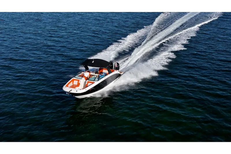 Slide: The Image of 2019 Sea Ray SDX 290 Outboard cruising on open water, creating a dynamic wake. - 77