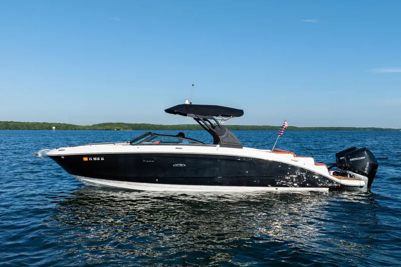 Slide: The Image of 2019 Sea Ray SDX 290 Outboard boat on calm blue water under clear sky. - 8