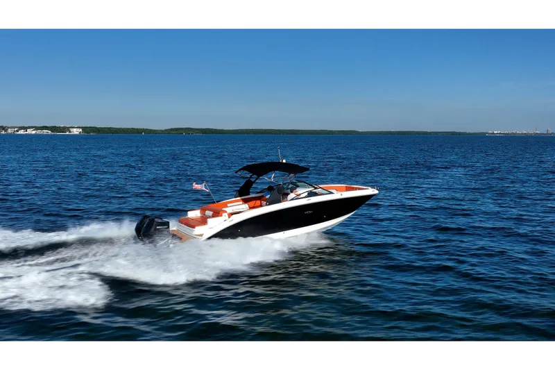 Slide: The Image of 2019 Sea Ray SDX 290 Outboard cruising on open water under clear blue skies. - 80
