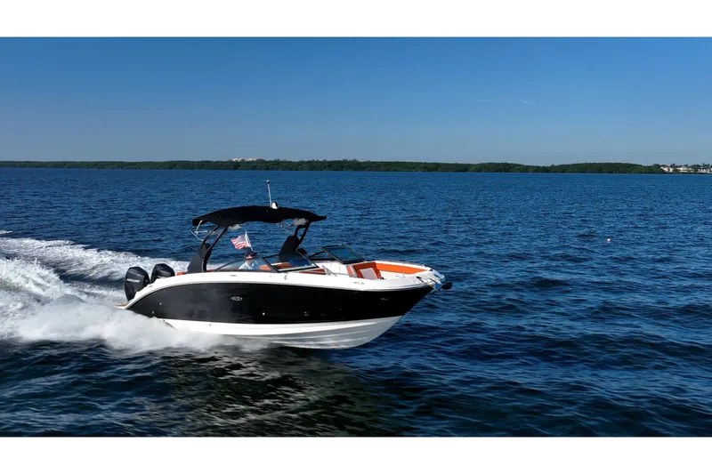 Slide: The Image of 2019 Sea Ray SDX 290 Outboard cruising on a clear blue lake. - 81