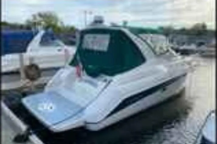Slide: The Image of 1997 Regal Commodore 3260 boat docked at marina, rear view with green canopy. - 1