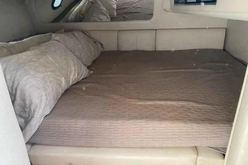 Slide: The Image of Interior cabin of 1997 Regal Commodore 3260 with cozy bed setup. - 10