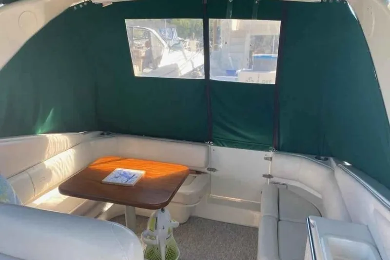 Slide: The Image of Interior of 1997 Regal Commodore 3260 boat with seating and table. - 11