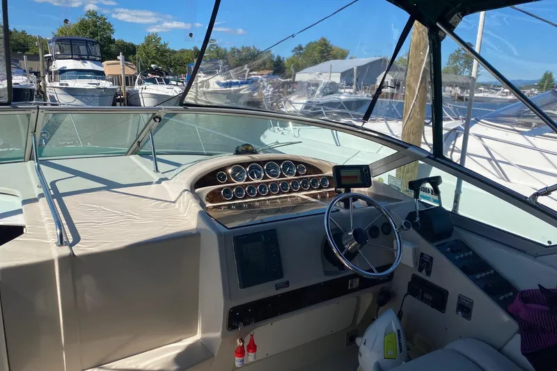 Slide: The Image of Interior view of 1997 Regal Commodore 320 boat cockpit with steering wheel and gauges. - 15