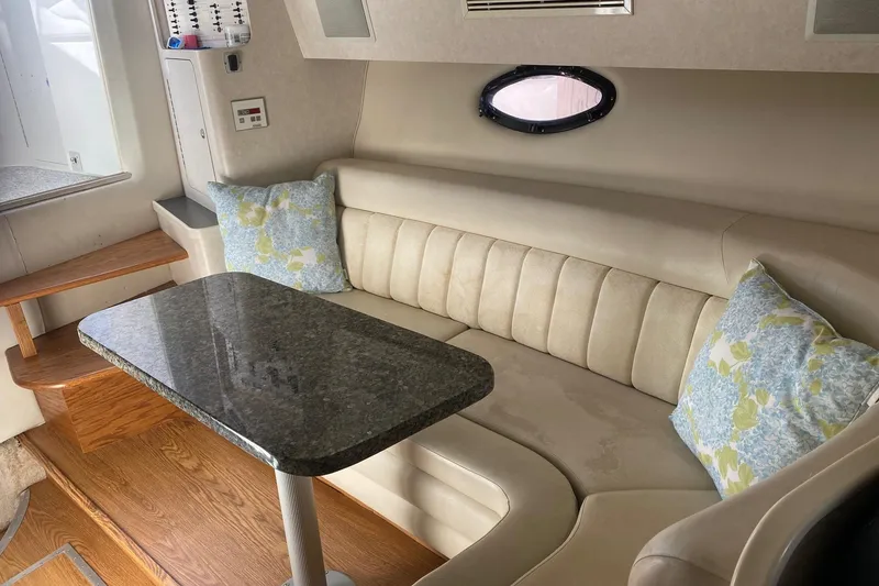Slide: The Image of Interior of 1997 Regal Commodore 320 yacht with plush seating and elegant table. - 18