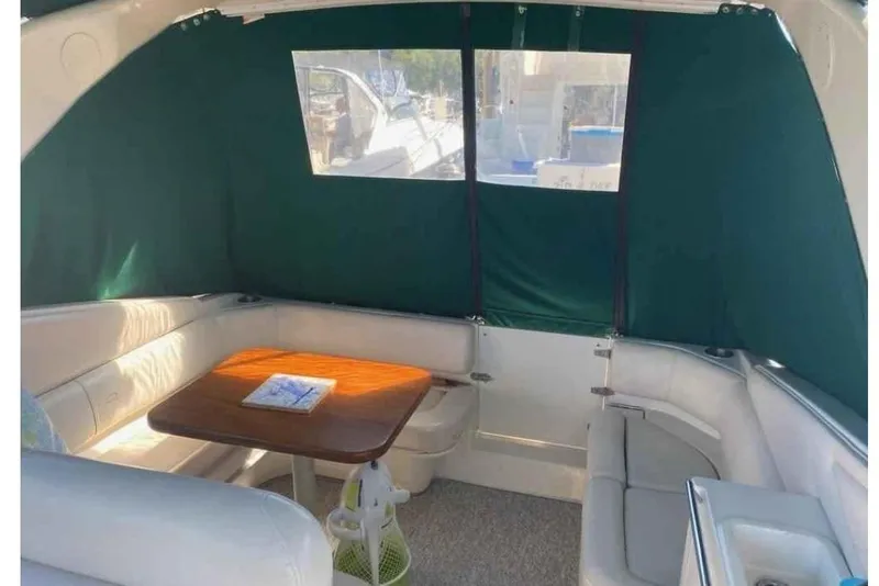 Slide: The Image of Interior of 1997 Regal Commodore 3260 boat with seating and table. - 3