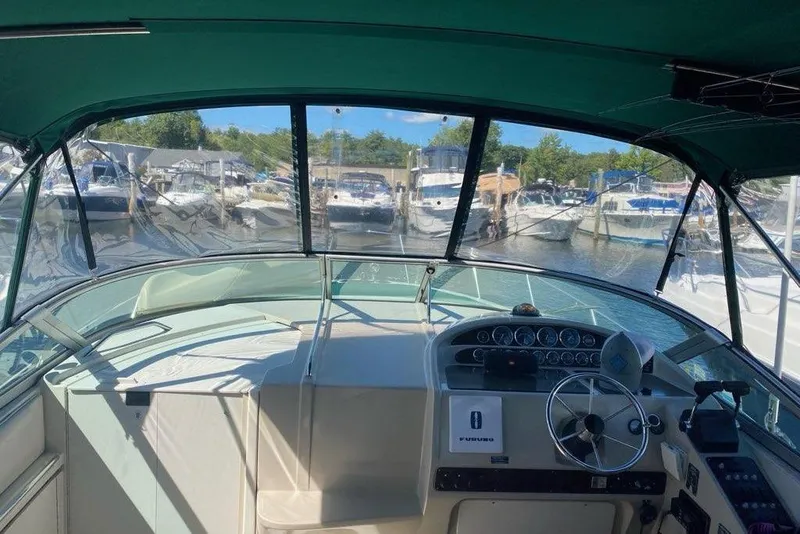 Slide: The Image of Interior view of 1997 Regal Commodore 3260 boat cockpit at marina. - 5