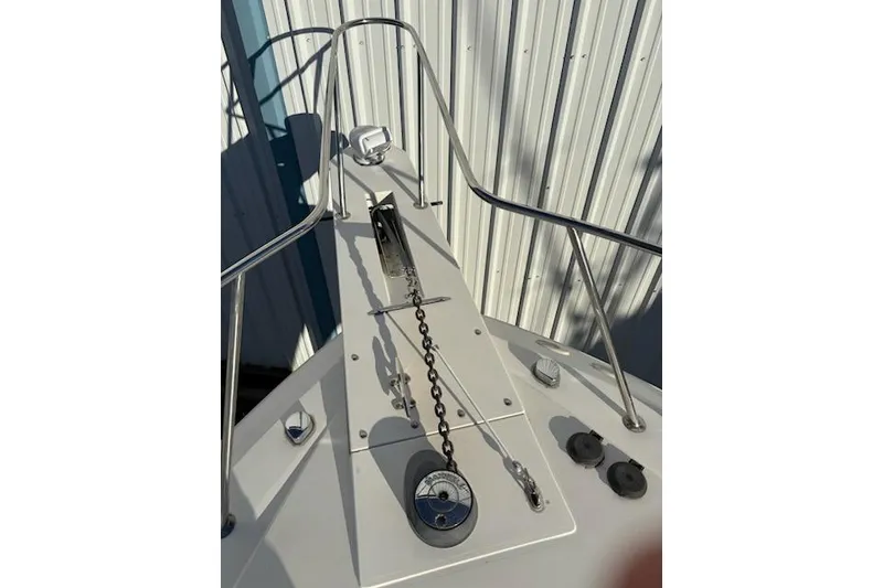 Slide: The Image of 2003 Wellcraft 3300 Coastal boat deck with anchor chain and railing. - 4