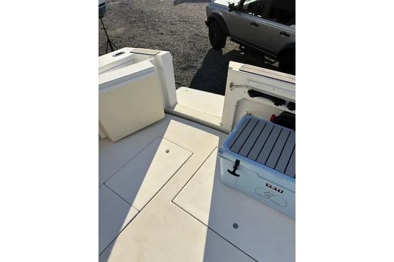 Slide: The Image of 2003 Wellcraft 3300 Coastal boat deck with storage compartments and cooler. - 5