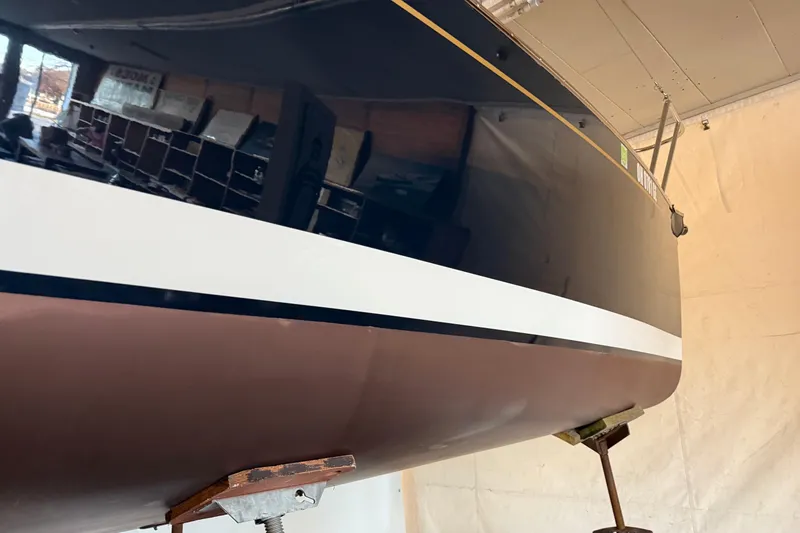 Slide: The Image of 2021 Tartan Fantail sailboat in storage, showcasing sleek hull design. - 10