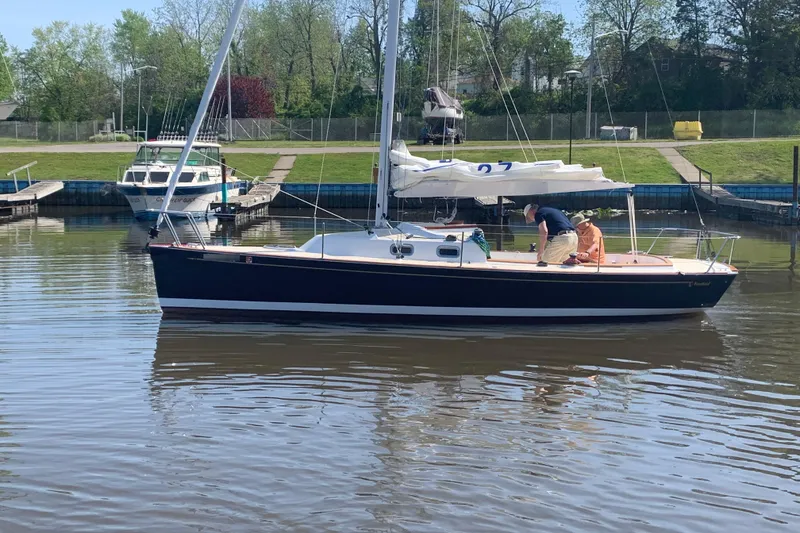 Slide: The Image of 2021 Tartan Fantail sailboat docked in a marina with two people onboard. - 4