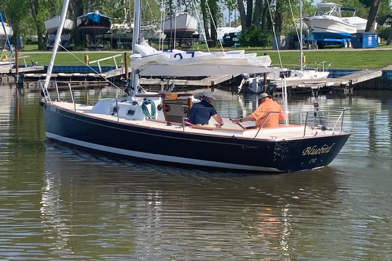 Slide: The Image of 2021 Tartan Fantail sailboat "Bluebird" on calm water near a marina. - 5