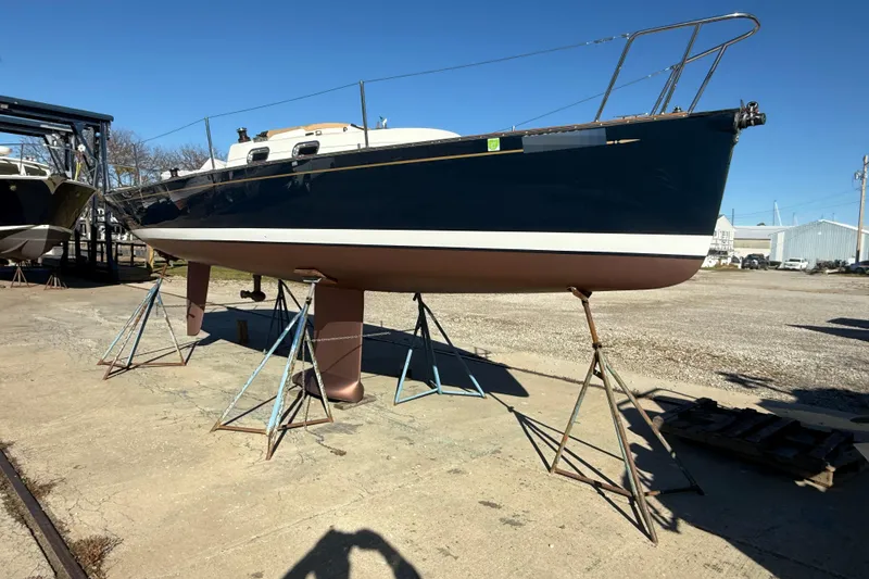 Slide: The Image of 2021 Tartan Fantail sailboat on stands in a boatyard under clear blue sky. - 7