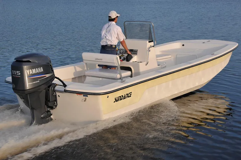 Slide: The Image of Manufacturer Provided Image: 2025 Sundance B22CCR boat on water with person steering, featuring Yamaha outboard motor. - 2