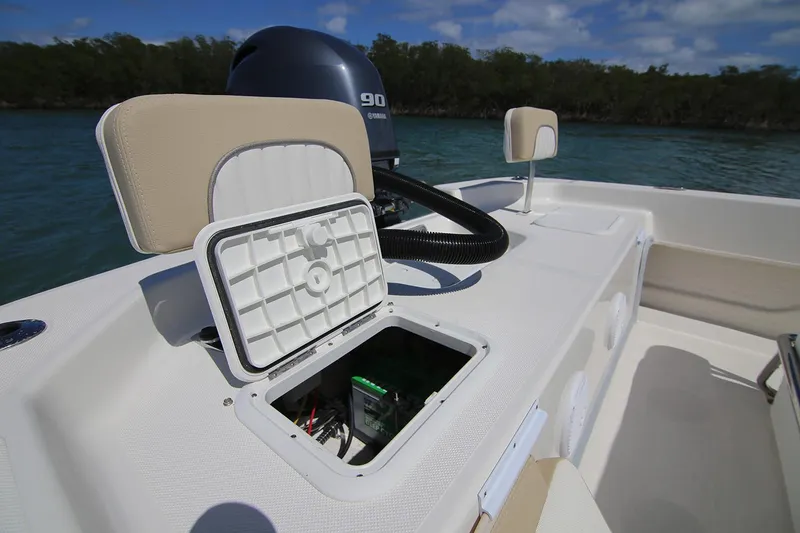 Slide: The Image of Manufacturer Provided Image: 2025 Sundance B22CCR boat interior with Yamaha 90 engine, featuring beige and white seating. - 9