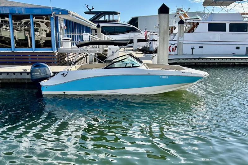 The Image of 2022 NauticStar 223 DC boat docked at marina with Yamaha outboard motor. - 1