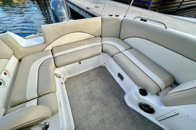 Slide: The Image of Luxurious seating area on a 2022 NauticStar 223 DC boat, docked by the water. - 11