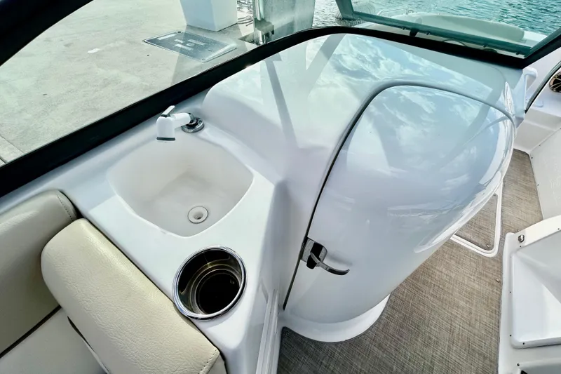 Slide: The Image of 2022 NauticStar 223 DC boat interior with sink and cup holder. - 12