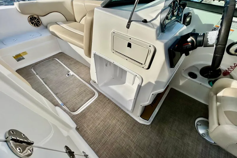Slide: The Image of Interior of 2022 NauticStar 223 DC boat, featuring seating and control panel. - 13