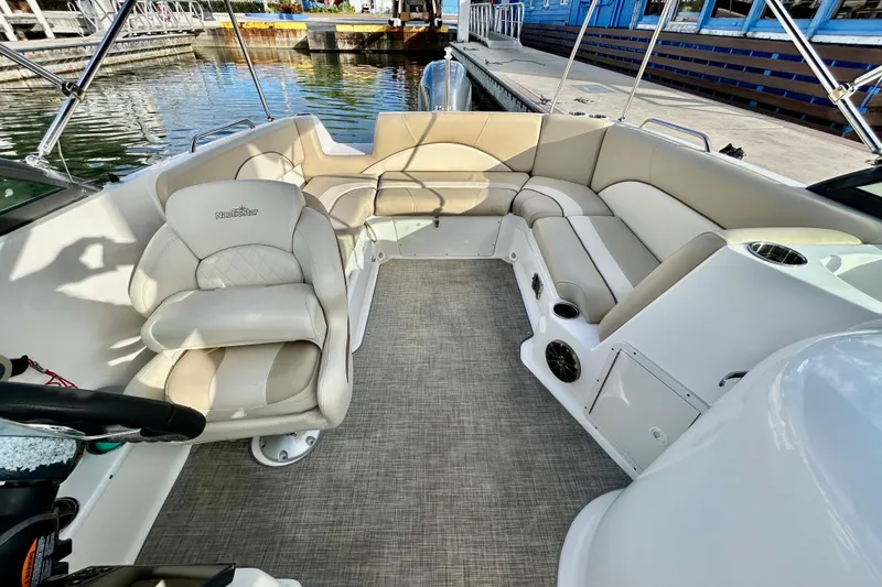 Slide: The Image of 2022 NauticStar 223 DC boat interior with beige seating and modern design. - 6