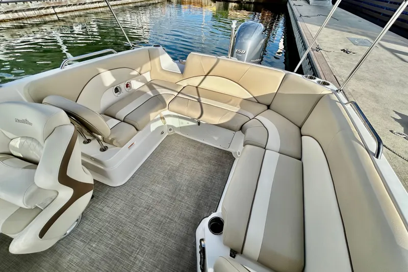 Slide: The Image of 2022 NauticStar 223 DC boat interior with beige seating and modern design. - 7