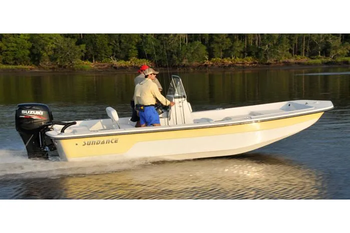 Slide: The Image of Manufacturer Provided Image: 2025 Sundance B20CCR boat cruising on a calm lake with two passengers. - 4