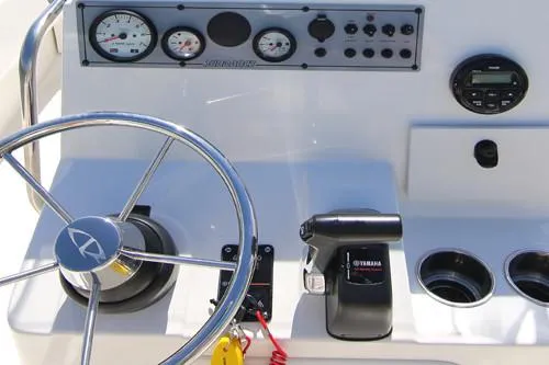 Slide: The Image of Manufacturer Provided Image: 2025 Sundance B20CCR boat cruising on water with two people onboard, featuring a Suzuki outboard motor. - 7