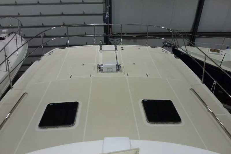 Slide: The Image of 2009 Maine Cat P-47 boat deck with railings and hatches in a storage facility. - 13