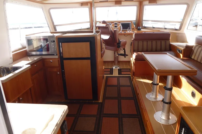Slide: The Image of Interior of 2009 Maine Cat P-47 yacht with kitchen, seating, and helm station. - 14