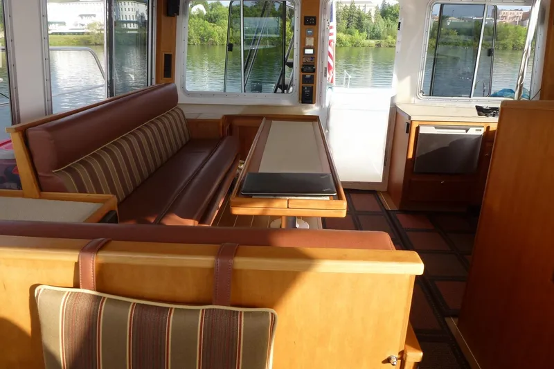 Slide: The Image of Interior of 2009 Maine Cat P-47 boat with seating and table, overlooking water. - 16