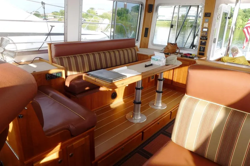 Slide: The Image of Interior of 2009 Maine Cat P-47 yacht with elegant seating and table setup. - 17